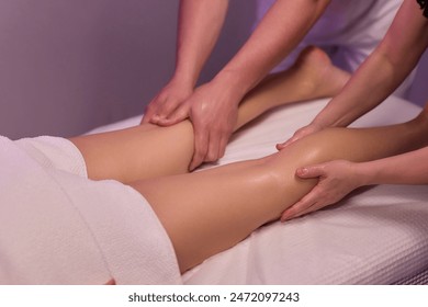 Professional therapists provide a soothing and relaxing leg massage therapy session to enhance well-being. - Powered by Shutterstock