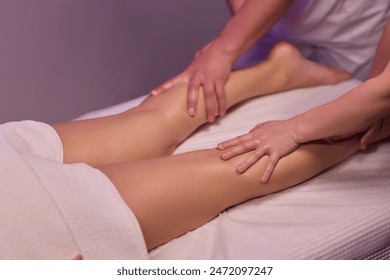 Professional therapists provide a soothing and relaxing leg massage therapy session to enhance well-being. - Powered by Shutterstock