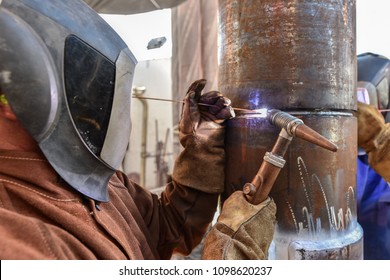 Professional TIG Welders Welding The Athwart Root Pass Of A Steel Pipeline With Old Rustic Welding Torch