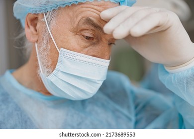 Professional Tired Surgeon In Mask Standing In Operating Room After Major Surgery