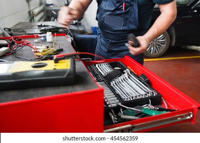 Professional Toolbox With Modern Tools At Garage. Mechanic Taking Facilities From Special Box For Mechanical Instruments