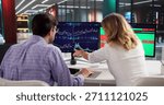 Professional Trader Using Multiple Computer Screens To Analyze Stock Market.