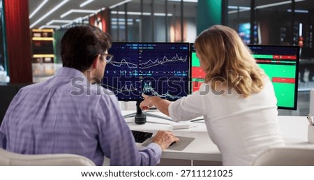 Professional Trader Using Multiple Computer Screens To Analyze Stock Market.