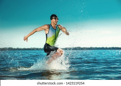 Professional Triathlete Swimming In River's Open Water. Man Wearing Swim Equipment Practicing Triathlon On The Beach In Summer's Day. Concept Of Healthy Lifestyle, Sport, Action, Motion And Movement.