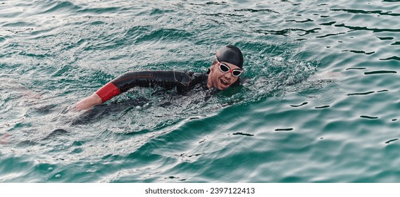 A professional triathlete trains with unwavering dedication for an upcoming competition at a lake, emanating a sense of athleticism and profound commitment to excellence. - Powered by Shutterstock