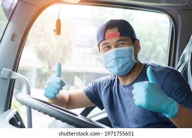 Professional Truck Driver Asian Man Wear Mask And Medical Gloves To Prevent Coronavirus While Driving. Owner Business Transportation Male Mature Adult Happy Smiling Pride Success  Long Time Service.