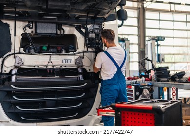 Professional truck mechanic working in vehicle repair service. - Powered by Shutterstock