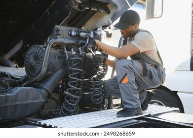 Professional truck mechanic working in vehicle repair service. - Powered by Shutterstock