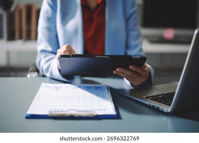 Professional using digital tablet in office, symbolizing technology, innovation, productivity, and teamwork in business communication and digital workflow.