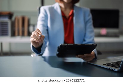 Professional using digital tablet in office, symbolizing technology, innovation, productivity, and teamwork in business communication and digital workflow.