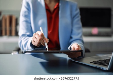 Professional using digital tablet in office, symbolizing technology, innovation, productivity, and teamwork in business communication and digital workflow.