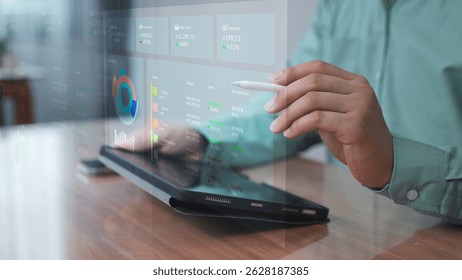 Professional using laptop with holographic dashboard and graphs – Data visualization and performance tracking concept in digital workplace.