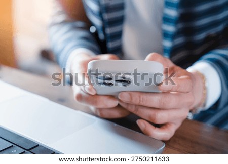 Professional using smartphone and work on laptop desk,Replying to messages,Sending email. Modern business communication concept, Mobile technology,Customer support online workflow or online messaging