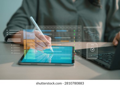 Professional using stylus pen on digital tablet planning corporate project timeline and Gantt chart