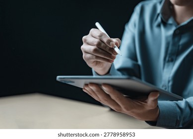 Professional using tablet and stylus for data analysis, audit review, financial reporting, project planning and digital business management in modern office workspace.