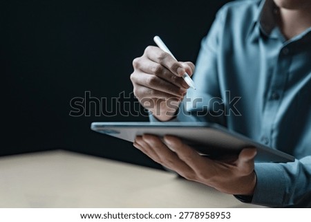 Professional using tablet and stylus for data analysis, audit review, financial reporting, project planning and digital business management in modern office workspace.