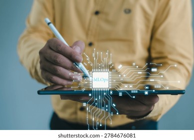 Professional using tablet and stylus with MLOps AI infrastructure interface for data automation, cloud systems, and scalable machine learning workflow.