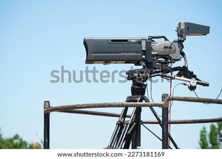 professional video camera located at height. telephoto lens.