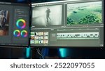 Professional video editor editing color grading and lighting in creative office, analyzing film montage, close up shot. Post production videographer manipulates raw footage, camera A