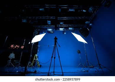 Professional video studio behind-the-scenes video footage behind-the-scenes silhouette production photography with a focus on camera and studio equipment. - Shutterstock ID 2258937899