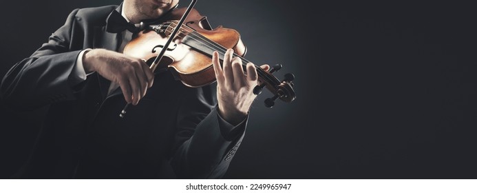 Professional violin player performing, classical music concept, banner with copy space