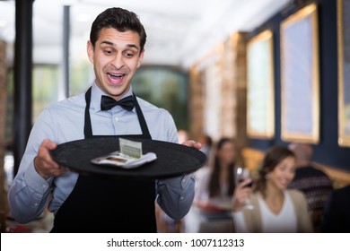 
Professional Waiter Holding Serving Tray In Restaurant With Tips