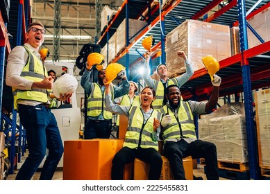 Professional warehouse worker team celebrating success in warehouse factory, Cheerful workers having fun at work, Happiness at job, Concept of success, Happy team enjoying their successful job - Shutterstock ID 2225455831