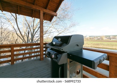 Professional Weber Grill On Wooden Terrace.