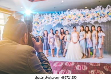 Professional Wedding Asian Photographer On Duty Take A Photo Group Of Bride And Friends.