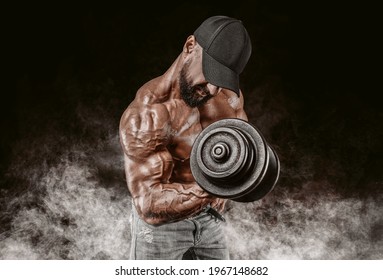 Professional weightlifter is training in the gym. Dumbbell Curl. Bodybuilding concept. Mixed media - Powered by Shutterstock