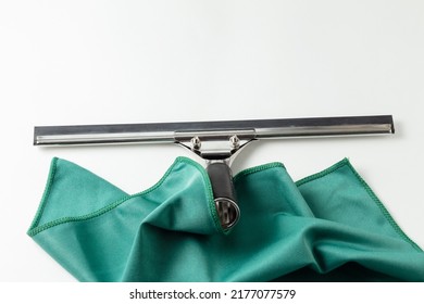 A Professional Window Cleaning Squeegee And A Green Microfiber Cloth. Specialized Cleaning Tool