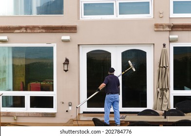  Professional Window Washer Cleaning House Windows With De-ionized Water Using An Extension Pole