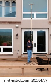  Professional Window Washer Cleaning House Windows With De-ionized Water Using An Extension Pole