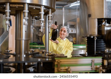 Professional winemaker controlling wine making process and quality at winery factory
