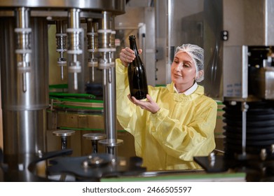 Professional winemaker controlling wine making process and quality at winery factory