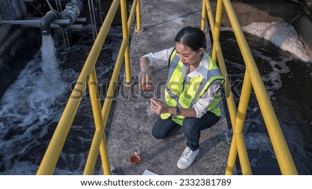 Professional Woman Engineer Inspecting Water at Waste Water Treatment Plant. Expertise of a Female Engineer Checking Water on a Waste Water Treatment Plant