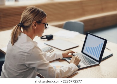 Professional woman financial analyst working on statistical statement on laptop in office - Powered by Shutterstock - Get 15% off with code: PIKWIZARD15