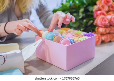 Professional Woman Floral Artist, Florist Making Gift Box With Flowers And Cake Macarons At Workshop, Flower Shop. Floristry, Biscuit, Holiday, Wedding, Birthday, Handmade And Small Business Concept