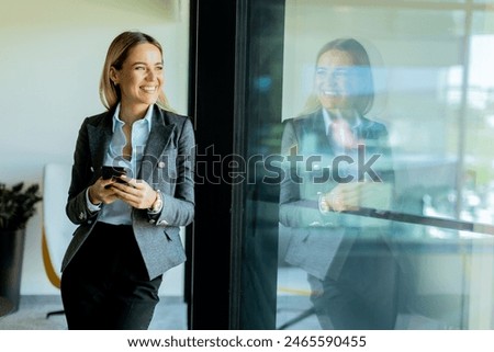 Similar – Image, Stock Photo Cheerful woman reflecting on urban building glass