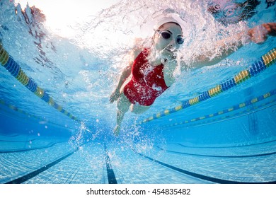 Professional woman swimmer inside swimming pool. - Shutterstock ID 454835482