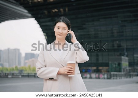 Professional Woman Taking a Call Outdoors in the City