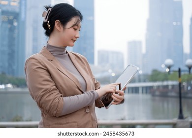 Professional Woman Using Tablet in Urban Landscape - Powered by Shutterstock