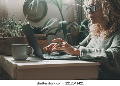 Professional woman working at home on laptop writing with concentrated expression. Modern female people using computer in indoor online leisure activity. Shopping or business smart work job freelance - Powered by Shutterstock