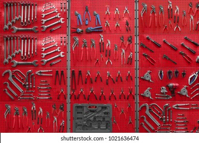 Professional Work Tools Hanging On Steel Wall As Background