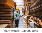 Professional worker team in safety uniform, supervisor inspector in packaging stock order at cardboard factory warehouse, piles of stacking paper manufacture, recycling industrial production