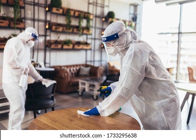 Professional Workers In Hazmat Suits Disinfecting Indoor Of Cafe Or Restaurant, Pandemic Health Risk, Coronavirus