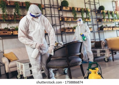 Professional Workers In Hazmat Suits Disinfecting Indoor Of Cafe Or Restaurant, Pandemic Health Risk, Coronavirus