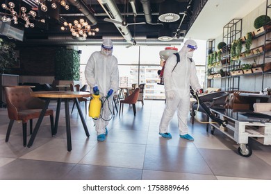 Professional Workers In Hazmat Suits Disinfecting Indoor Of Cafe Or Restaurant, Pandemic Health Risk, Coronavirus