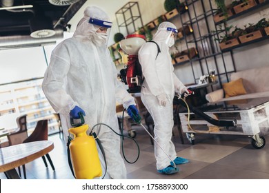 Professional Workers In Hazmat Suits Disinfecting Indoor Of Cafe Or Restaurant, Pandemic Health Risk, Coronavirus