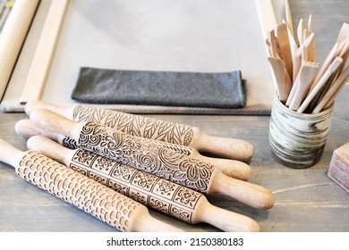 Professional working tools for working with clay.  Pottery shovels, brushes, rolling pin on wooden table. Flat lay, top view. - Powered by Shutterstock